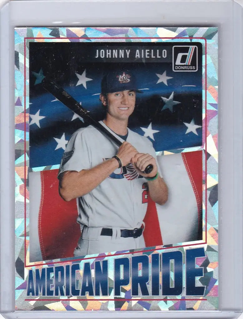 Baseball trading card of Johnny Aiello in white uniform with American flag background