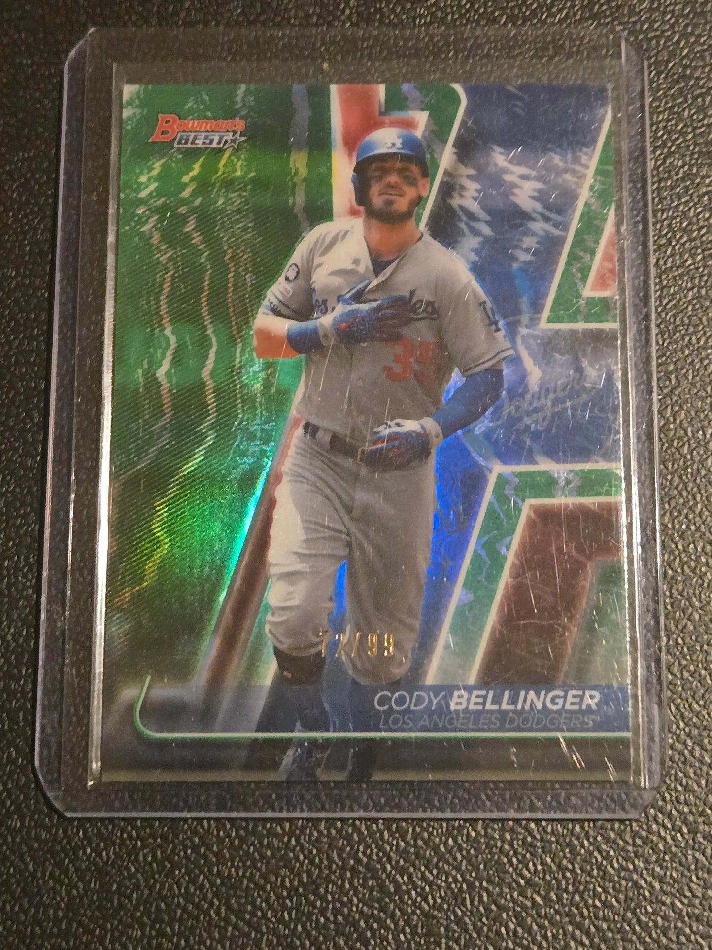 Cody Bellinger Green Refractor trading card in protective sleeve, numbered 7/99