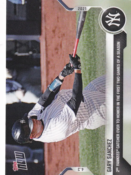 Baseball player Gary Sanchez swinging bat in white pinstripe uniform for New York Yankees