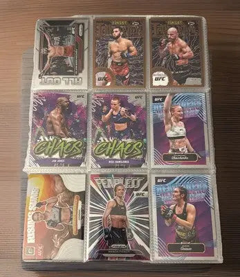UFC trading card lot in plastic sleeves featuring rookies, vets, Prizm, Refrac, and Base