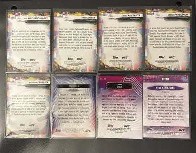 UFC trading card lot featuring rookies, vets, Prizm, Refrac, and base cards in sleeves
