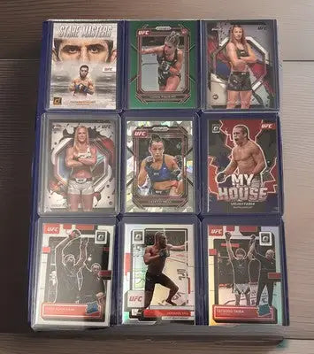UFC trading card display cases featuring a 2022-24 UFC 102 card lot collection
