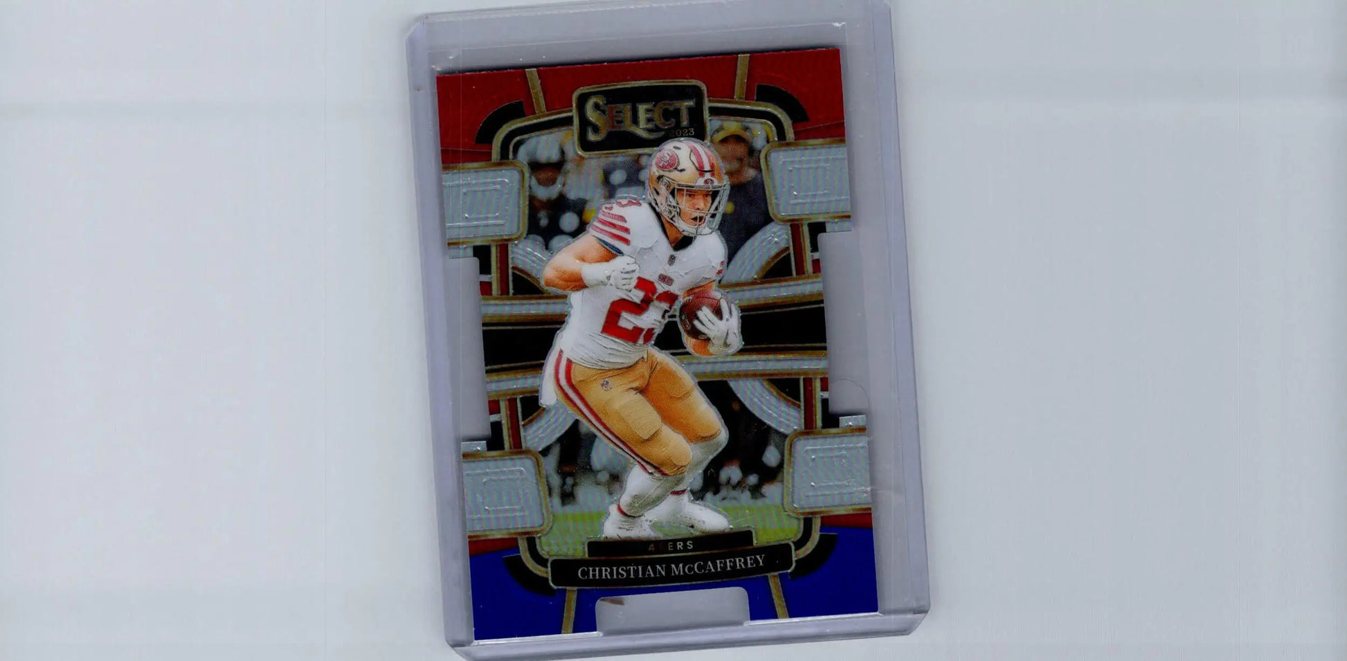 Football trading card of Christian McCaffrey in protective case from 2023 Panini Select featuring Black and Red Prizms Die Cuts