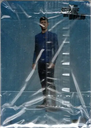 A figure in dark clothing through wrinkled plastic on a Star Trek Strange case topper card