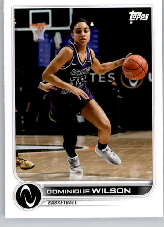 Dominique Wilson Basketball Card featuring player dribbling in dark uniform