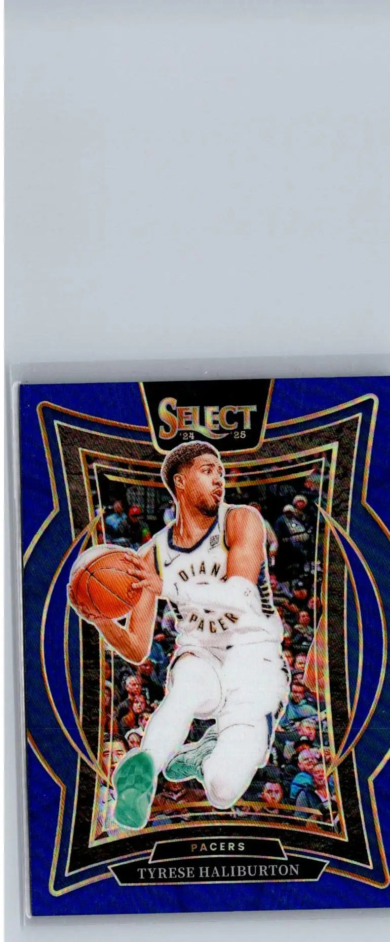 Tyrese Haliburton Blue Prizm basketball trading card featuring Haliburton dribbling against starburst background