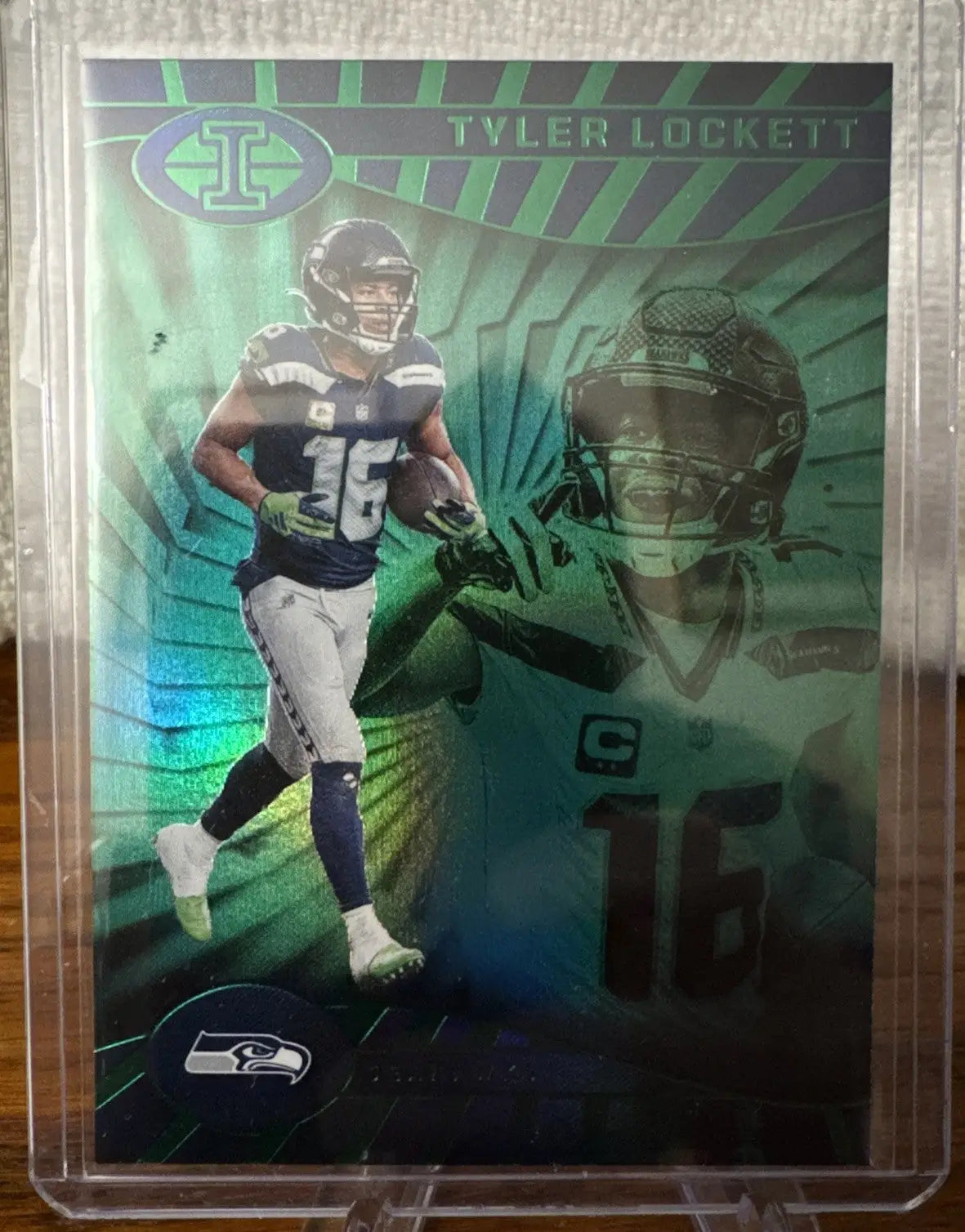 Glossy Tyler Lockett football trading card in illusions emerald green holographic finish
