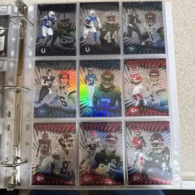 Binder page with nine holographic Panini Illusions trading cards from the 2024 base set