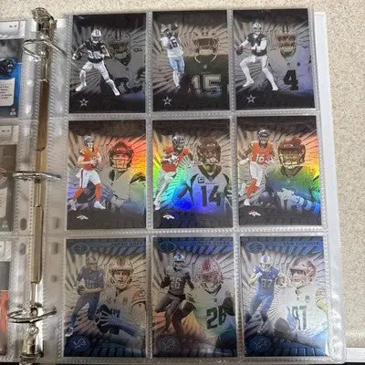 Binder page with nine holographic Panini Illusions trading cards from 2024 base set