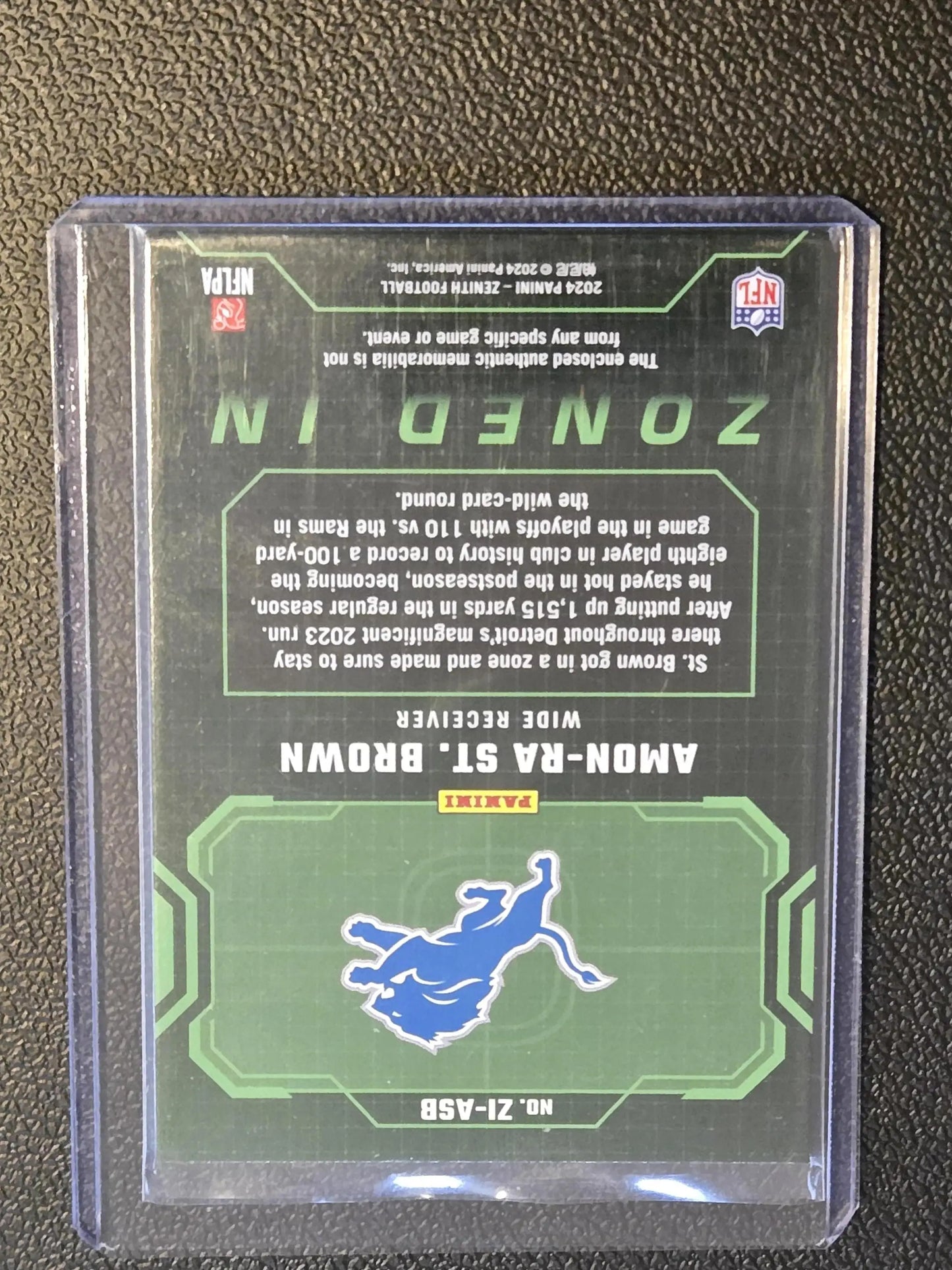 2024 Panini Zenith Amon-Ra St. Brown Zoned In football trading card in protective sleeve