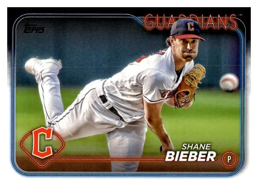 Cleveland Guardians Shane Bieber baseball card depicting mid-throwing motion action