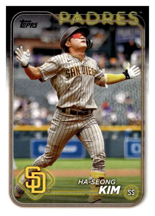 A San Diego Padres player celebrates with arms raised in a baseball card image