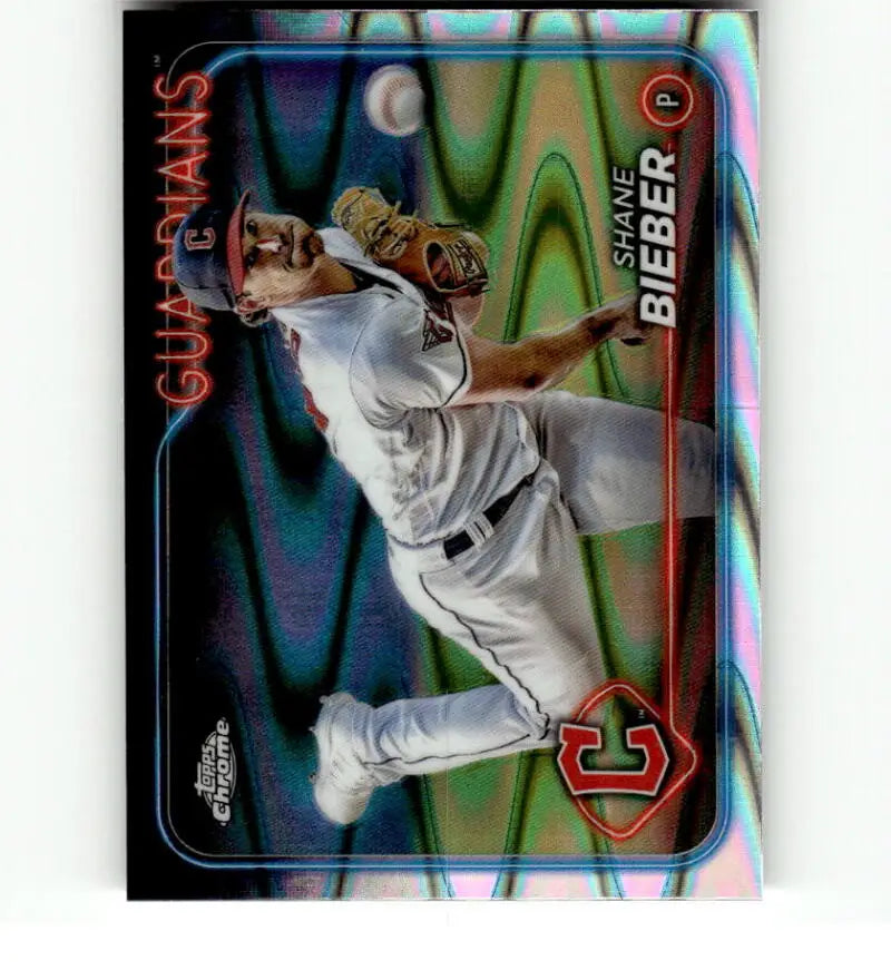 Shane Bieber pitching in white uniform on 2024 Topps Chrome Refractor card for Cleveland Guardians