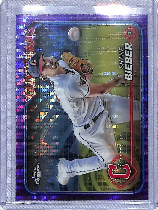 Shane Bieber making a throwing motion on a Sonar Purple baseball card