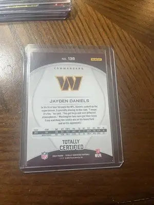 Sports trading card of Jayden Daniels in protective sleeve from 2024 Totally Certified Jayden series
