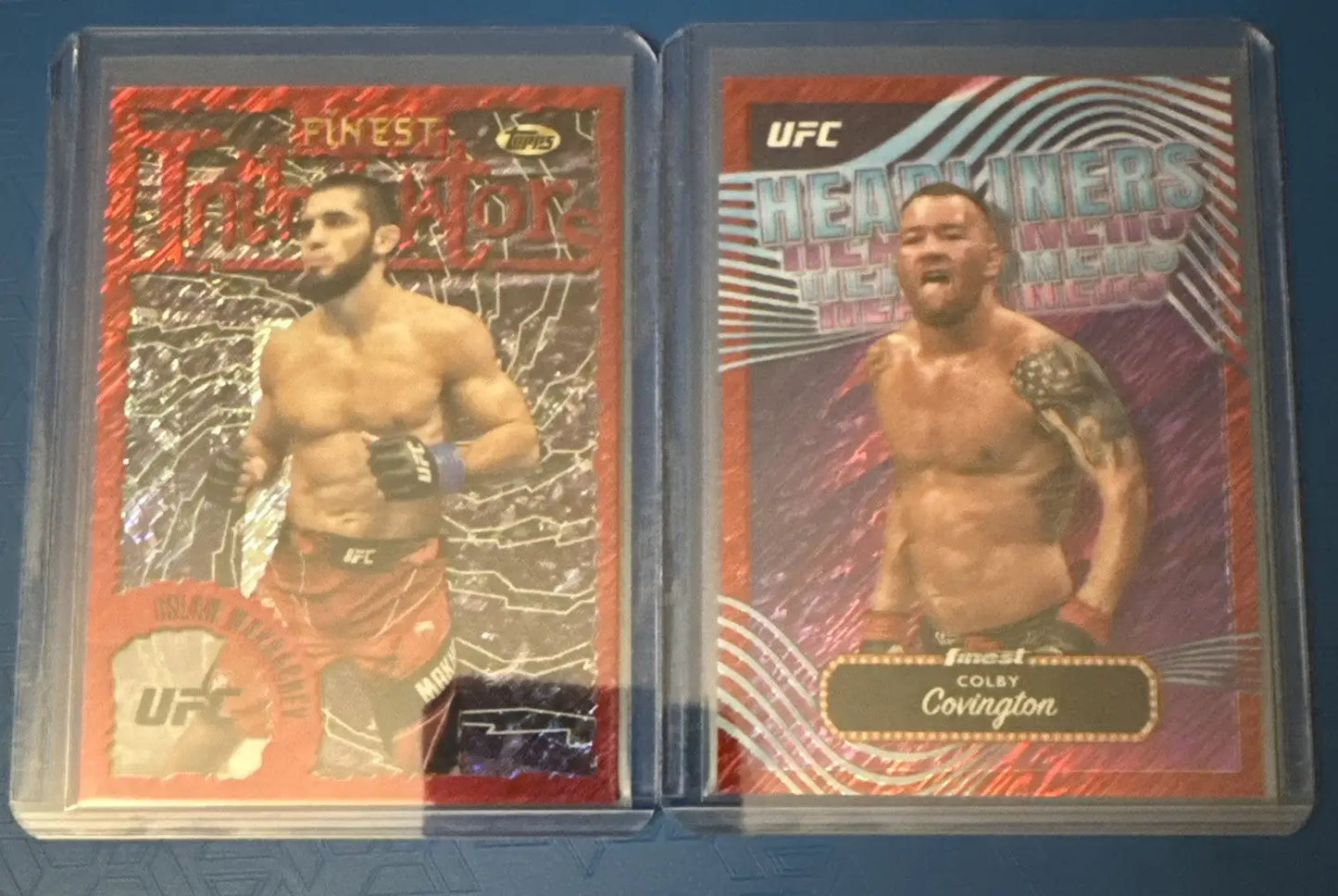 UFC trading cards in protective sleeves from 2024 Topps Red Shimmer collection featuring Covington Neal Usman Katona