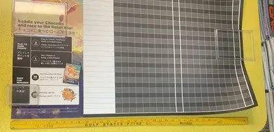 Grid-patterned cutting mat from Wizards MTG Final Fantasy Set Chocobo Racing promo