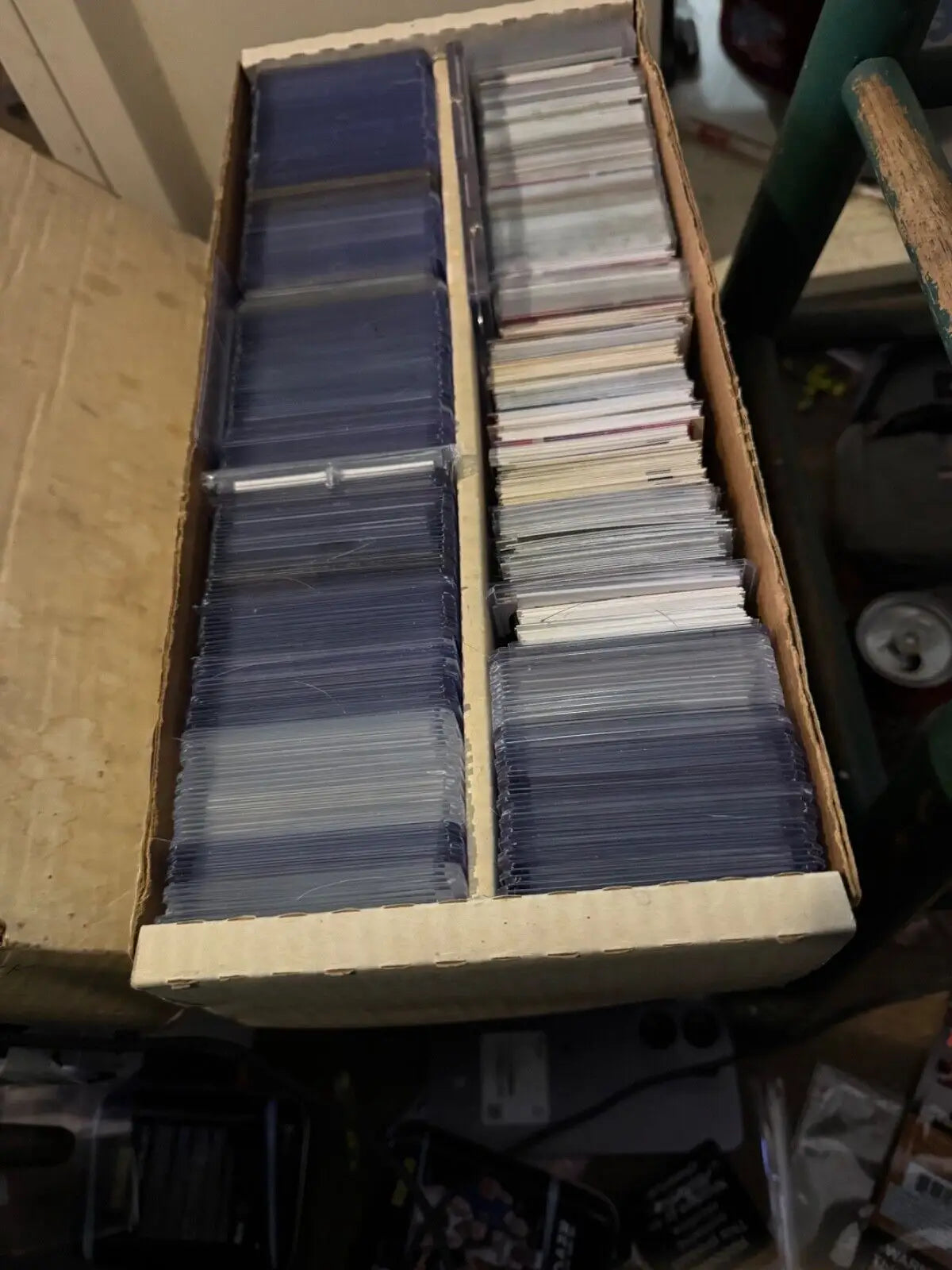 Cardboard box filled with random sports cards, featuring rookies and veterans