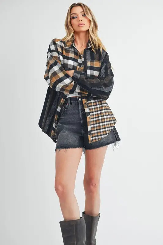 Women wearing Aem+Co Curved Hem Plaid Button Up Shirt with distressed denim shorts and dark gray boots