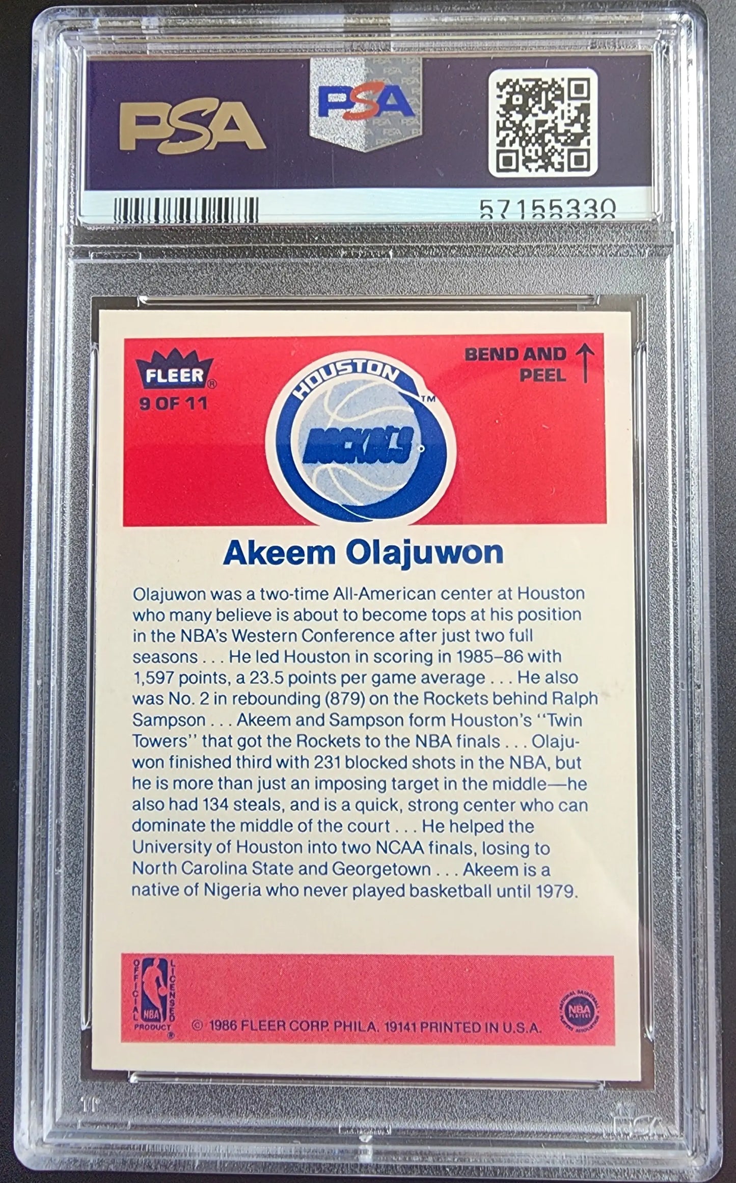 PSA-graded Akeem Olajuwon 1986 Fleer Stickers #8 trading card with red background