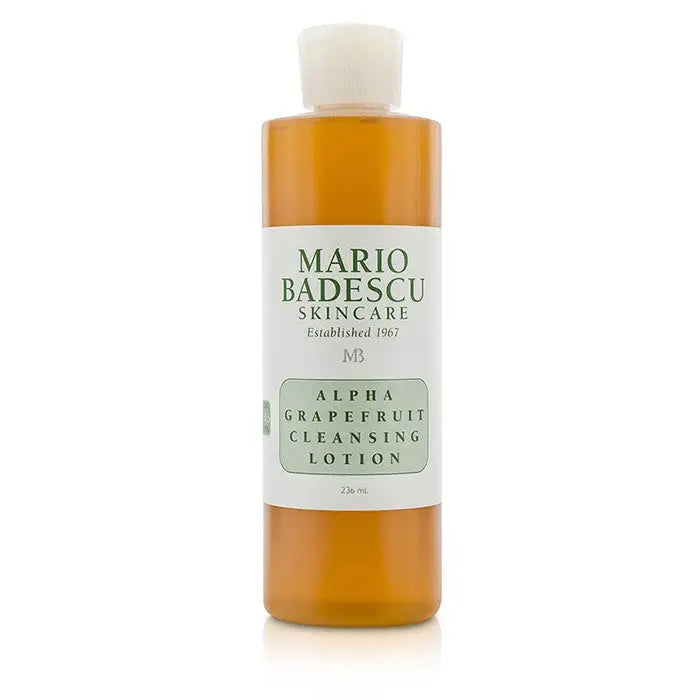 Orange liquid cleanser in a clear plastic bottle with white cap for Alpha Grapefruit Cleansing Lotion