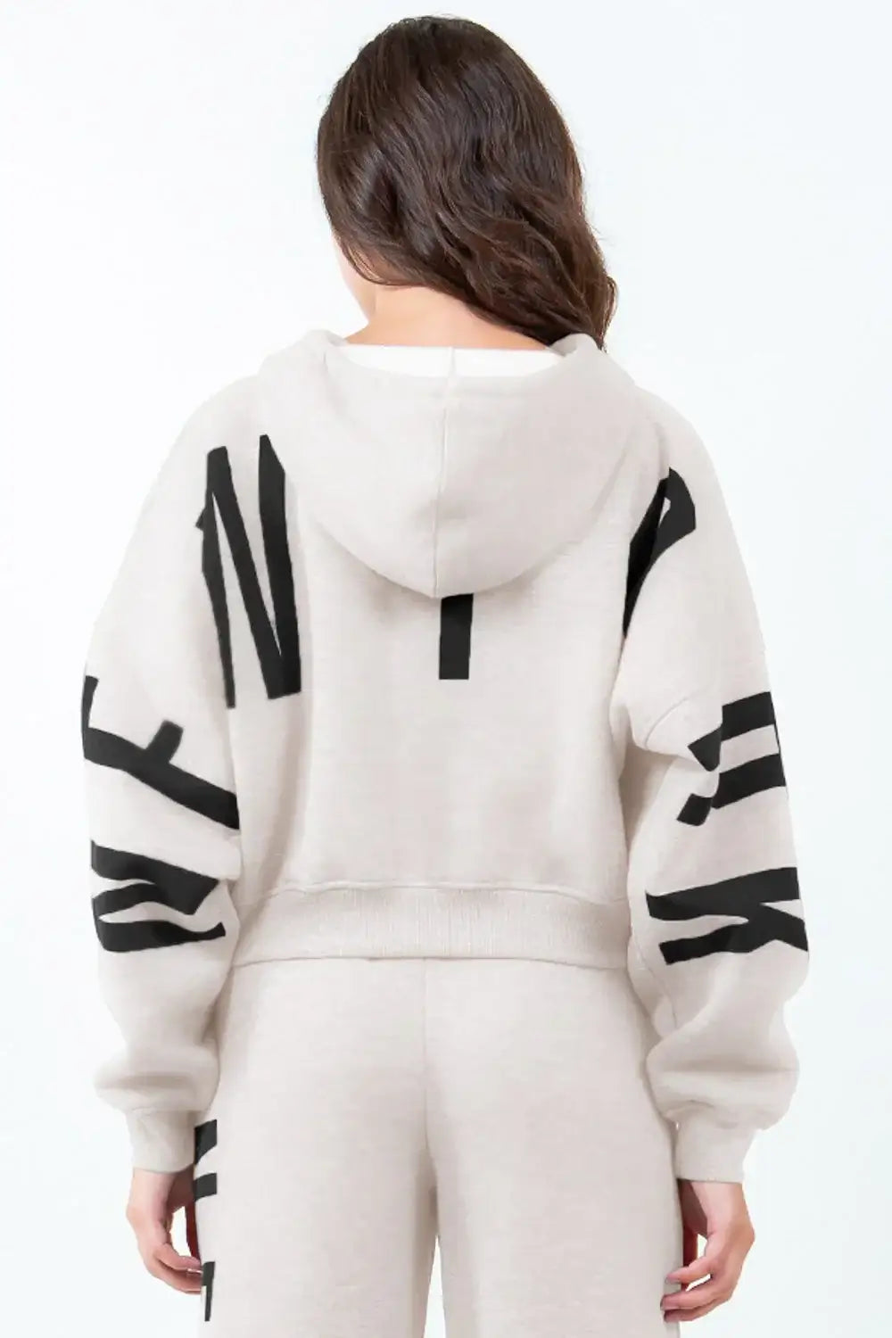 Light beige cropped hoodie with bold black letter graphic long sleeve design