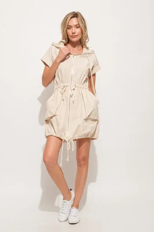 Light beige short sleeve string details hooded mini dress with front zipper and pockets
