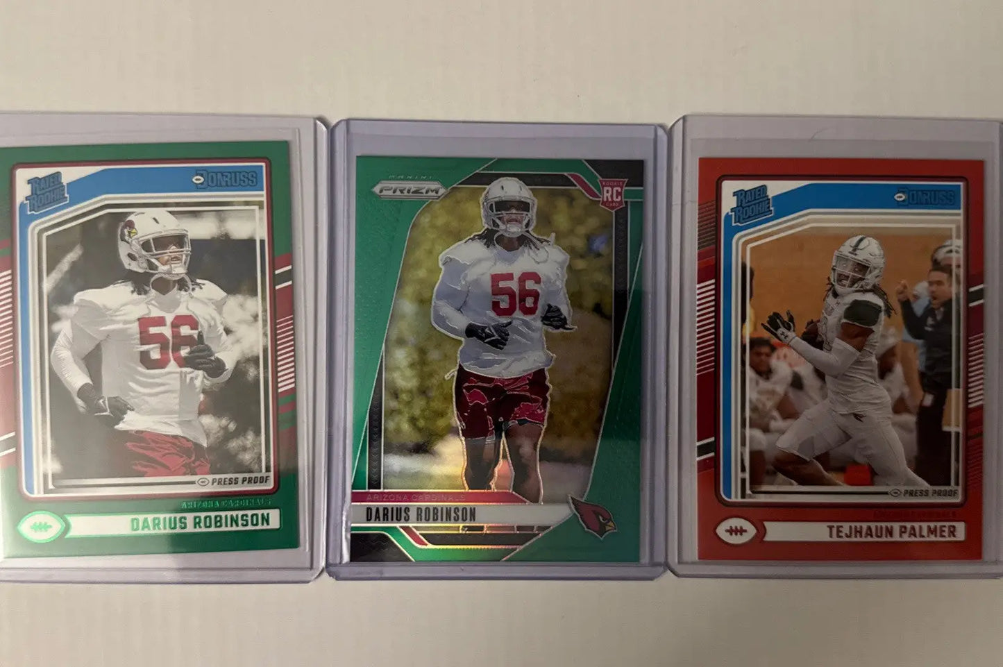 Arizona Cardinals RC lot featuring collectible football trading cards in protective sleeves