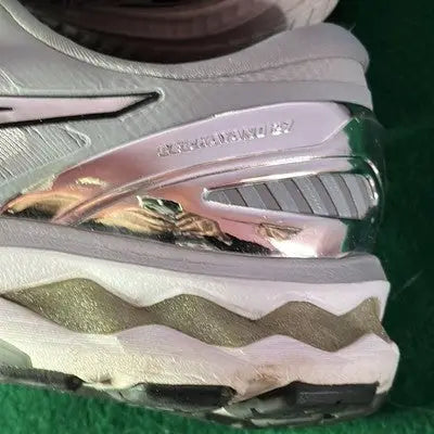 Close-up of Asics Pale Gray Low Top Running Shoes with silver and white athletic design