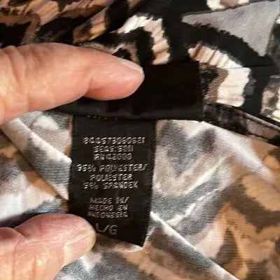 Clothing tag showing fabric composition and size for Attention Women’s Black White Long Sleeve Pullover Blouse