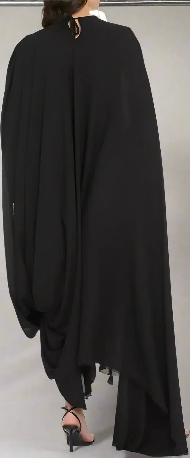 Balenciaga Black crepe dress with asymmetric hem, flowing cape, tassels, and high heels