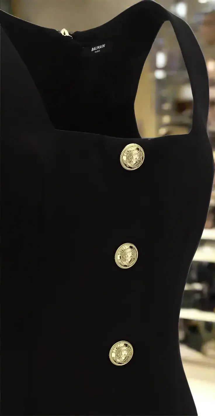 Black wool button dress by BALMAIN featuring a sleeveless design and gold decorative buttons