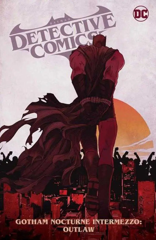 Dark silhouetted figure in a flowing cape with Batman Detective Comics logo backdrop