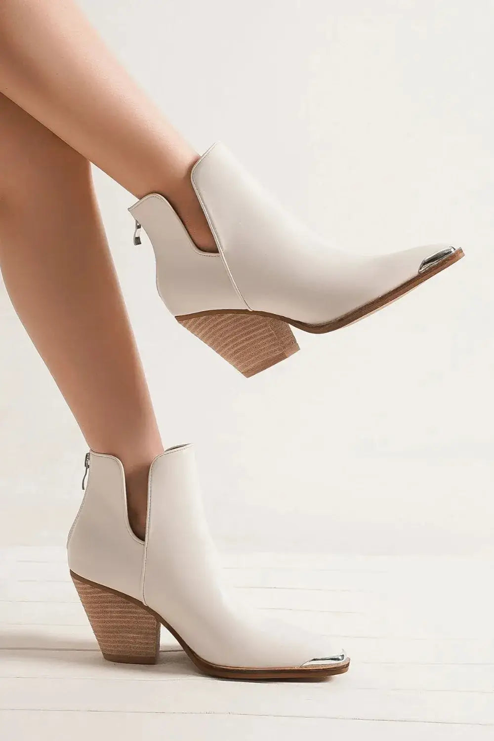 White leather block heel ankle boots with metallic toe cap and pointed design