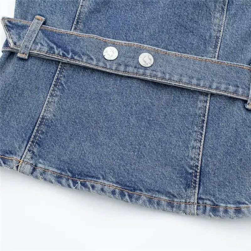 Blue denim corset top with stitched seam and silver buttons showcasing denim style