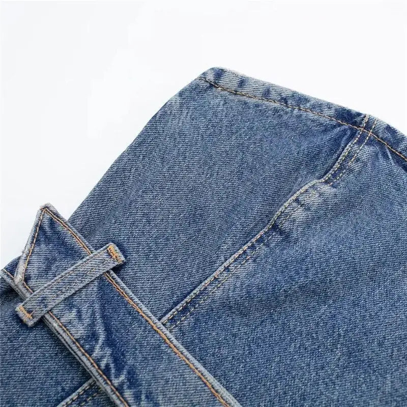 Close-up of blue denim corset top with stitching and belt loop in blue denim fabric