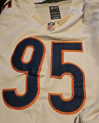 White Chicago Bears football jersey with number 95 featuring distressed and discolored details