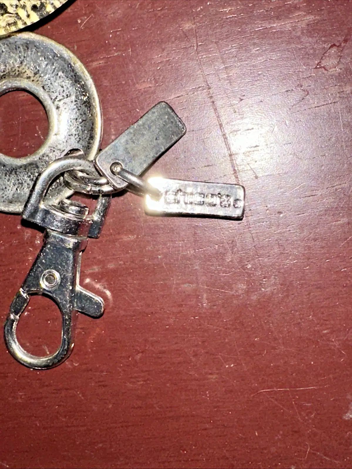 Silver-toned metal keychain with two rectangular tags and clasp, featuring silvertone chain accent