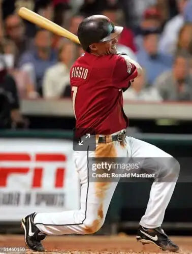 Baseball player swinging bat in Craig Biggio photo matched NIKE PRO game used cleats