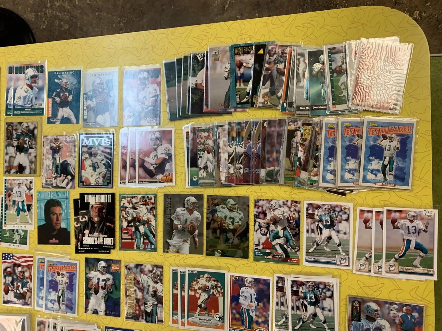 Assorted football trading cards featuring Dan Marino and Miami Dolphins collectibles