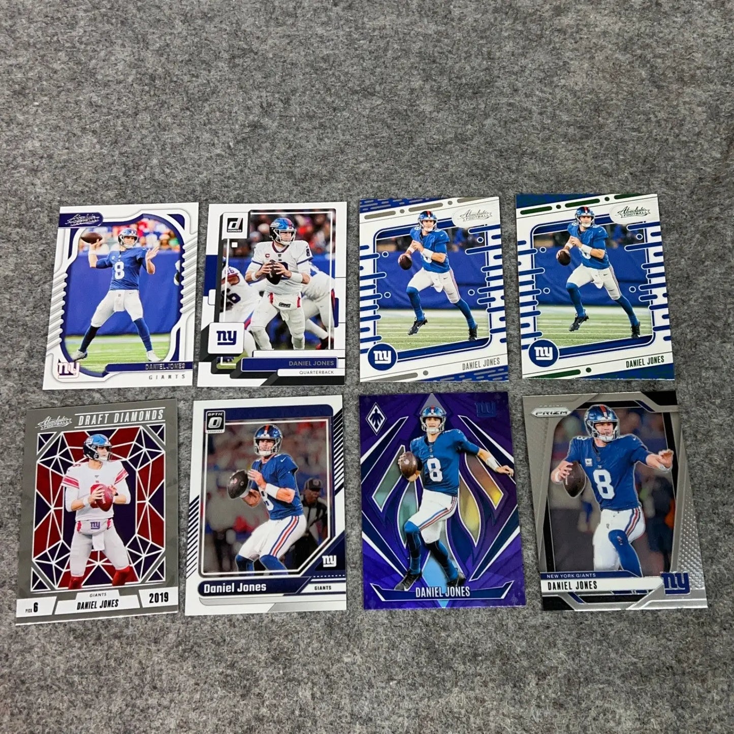 Collection of eight Daniel Jones New York Giants football trading cards from 2022 to 2024