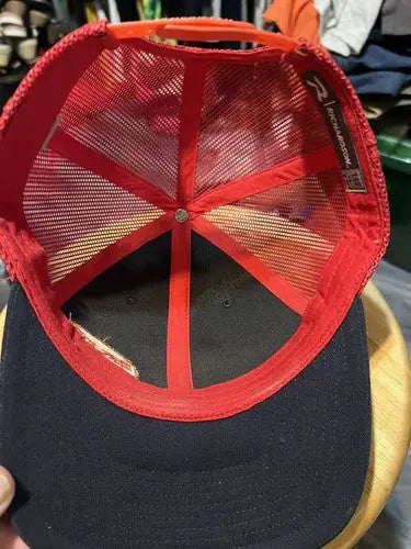 Underside of Dirt Inc Trucker SnapBack Hat with black and red mesh and snapback closure