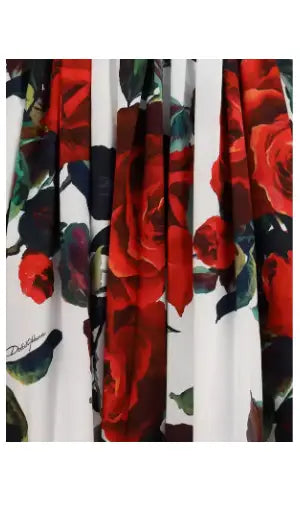 White fabric with red rose and green leaf pattern on Dolce & Gabbana rose patterned midi dress