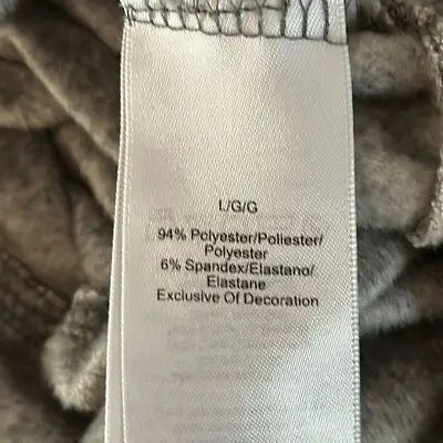 Garment care tag with fabric blend and size info on Donna Karan sleepwear pullover top