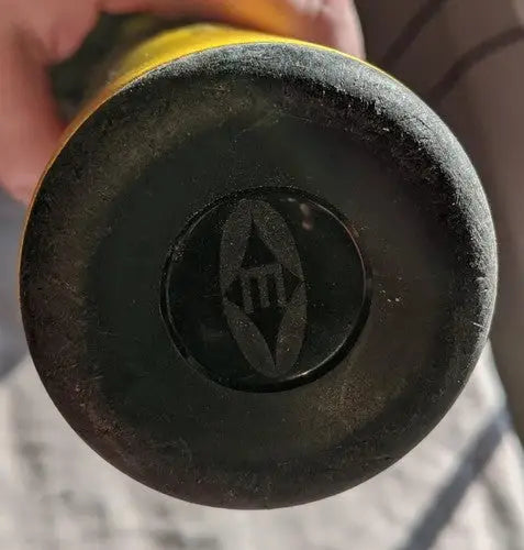 End cap of Easton Octane league baseball bat with prominent M logo