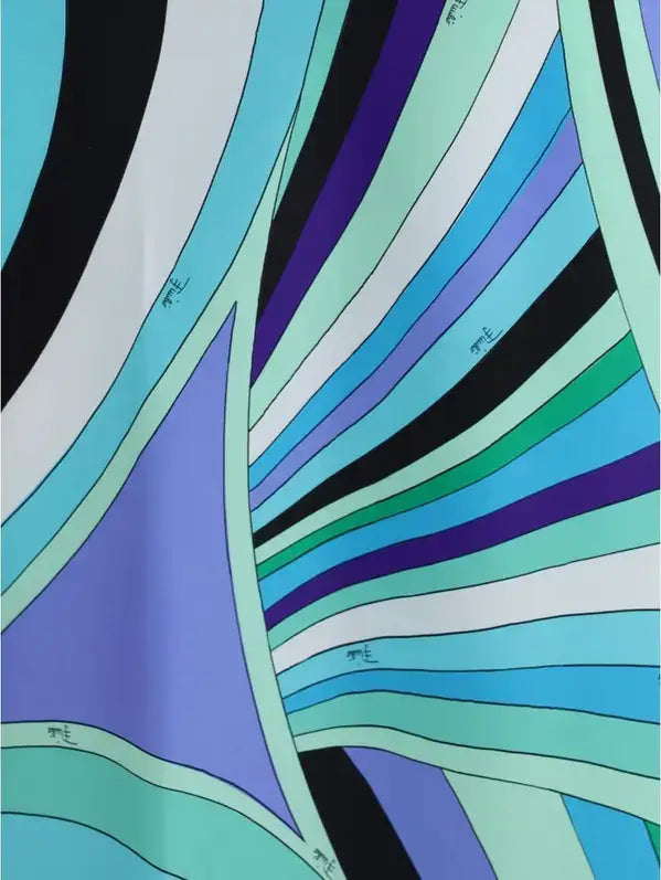 Vibrant abstract patterned fabric in shades of blue green purple black on Emilio Pucci Iride print long dress