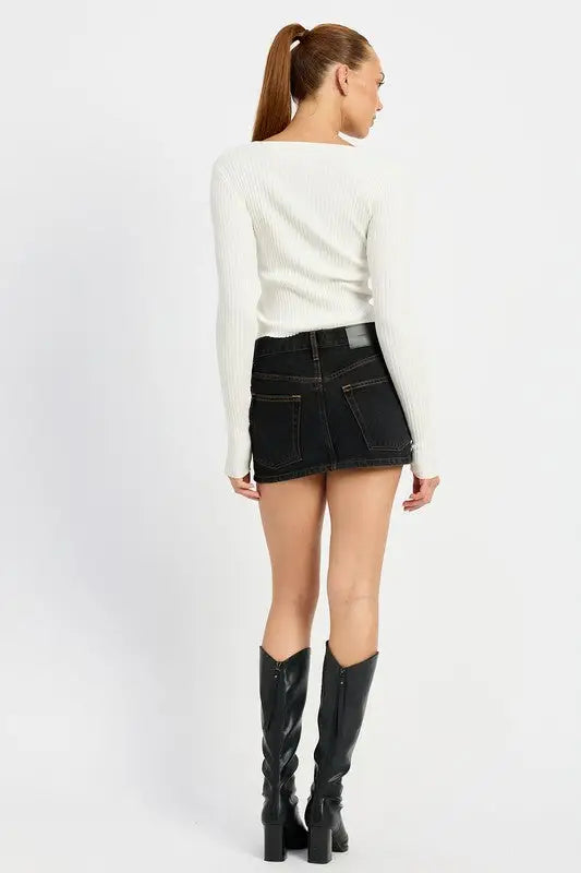 Black denim mini skirt with faded wash paired with Emory Park long sleeve ivory top