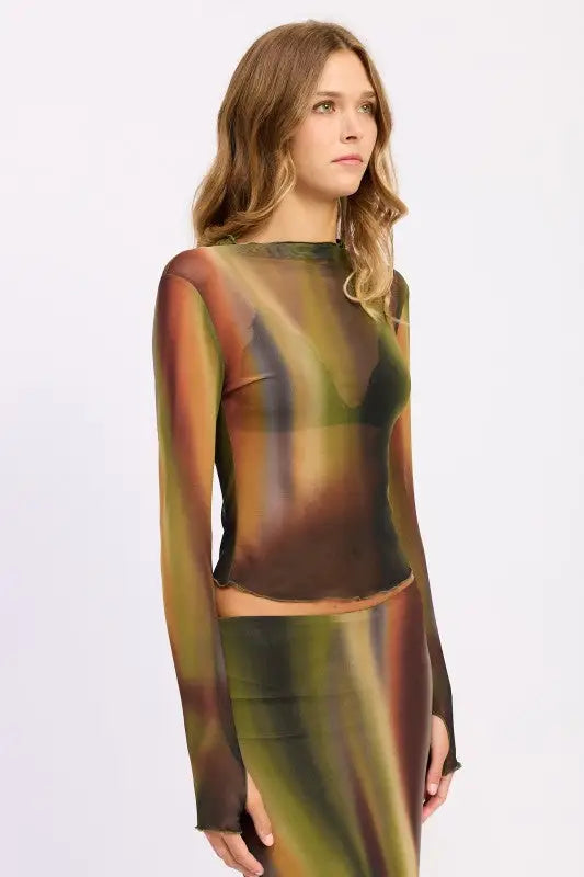 Woman modeling Emory Park long sleeve mesh lounging top with abstract swirl pattern and matching midi skirt