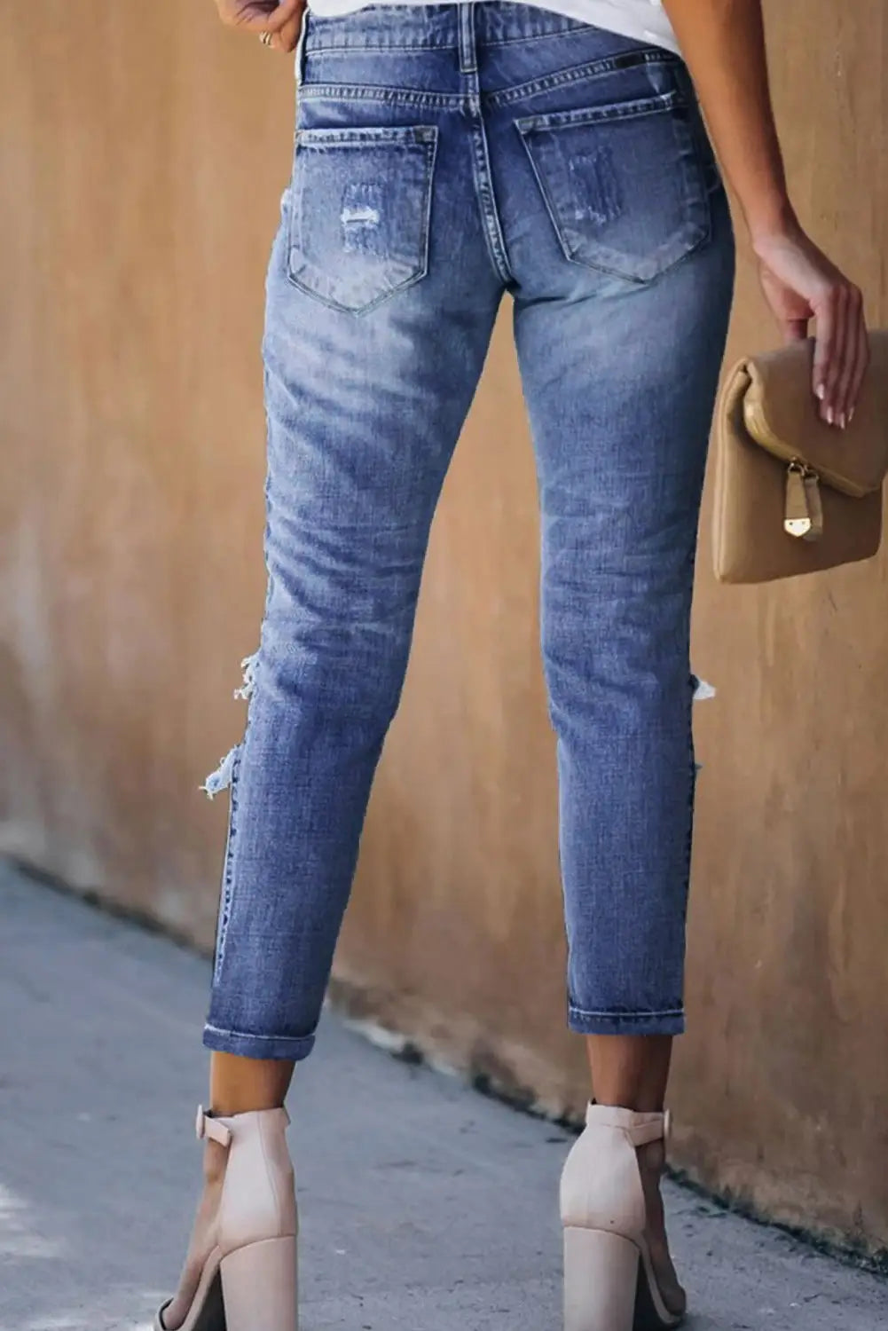 Light wash fading distressed holes crop jeans with rolled cuffs for a casual look