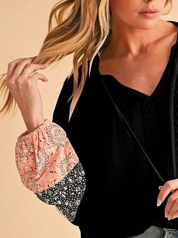Black floral patchwork top with long sleeves and contrasting patterned bell sleeves